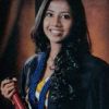 Portrait of MA student Chamila Karunarathne, she is smiling and holding a degree scroll.