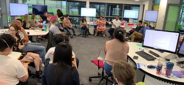 Attendees sit together in a circle with Dr Sami Schalk, Ms Tasnim Hassan, and Prof Scott Avery engaged in a discussion.