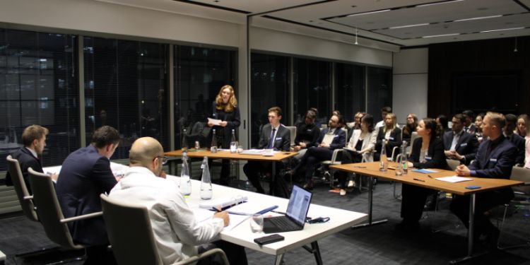 A woman speaks to a room of people