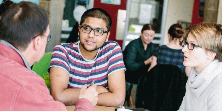 Students chatting with their tutor