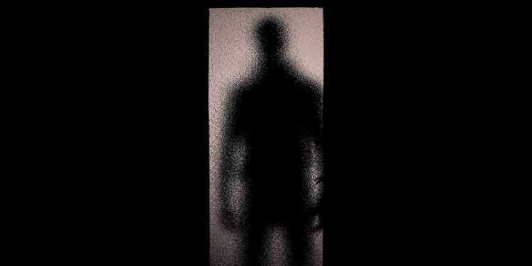 Shadowy figure in doorway