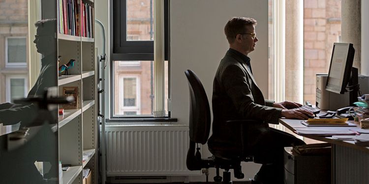 Michael Thomson at his desk