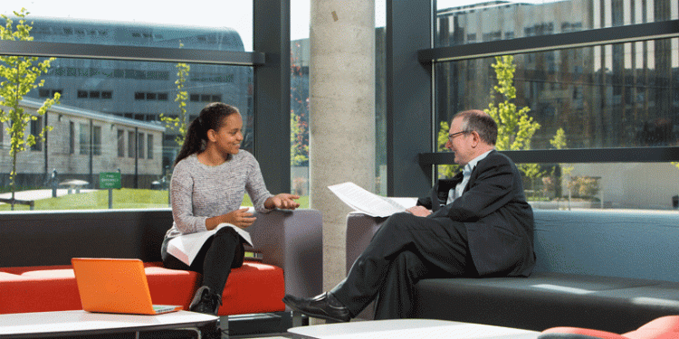 student and academic staff member talking in the Liberty Building