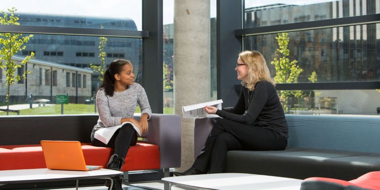 Joan Loughrey with a student in the Liberty Building foyer