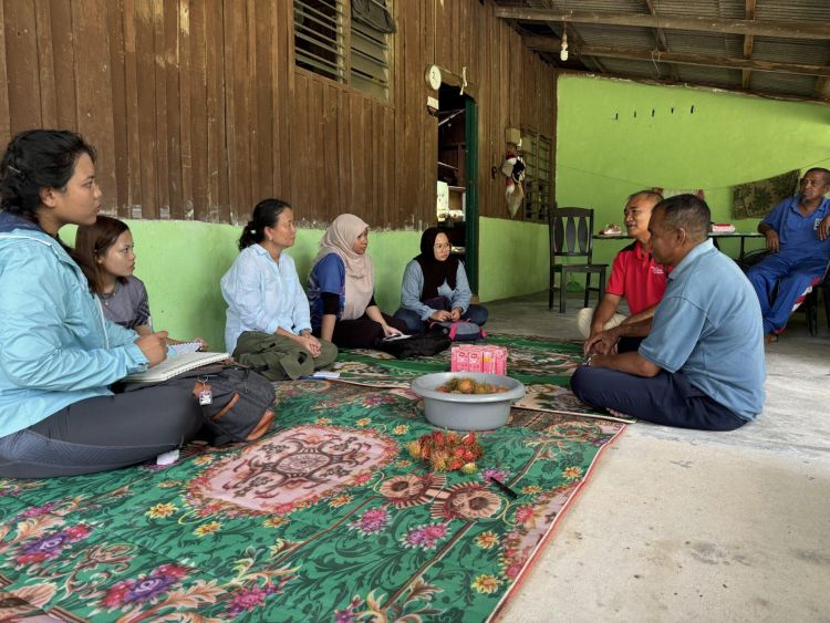 People sat on a rug in Malaysia