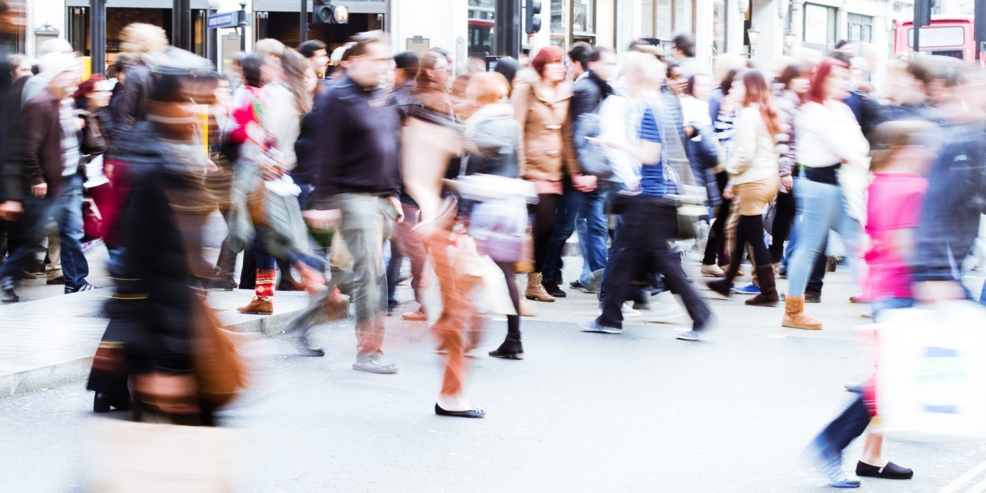Blurred crowd of people moving on the street
