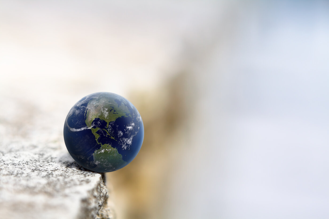 An image of the world on the edge of a cliff