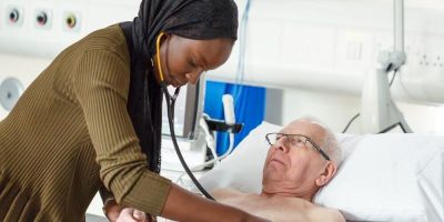 A doctor treating a patient in a hospital bed