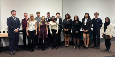 Group of students stand together facing the camera