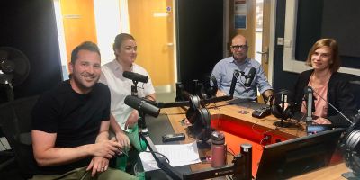 Academics and host discussion in the podcast studio