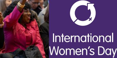 Woman cheering and raising her arm alongside logo of International Women's Day