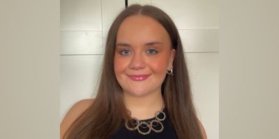 Student Sophie Balmer facing the camera, smiling, against a plain background