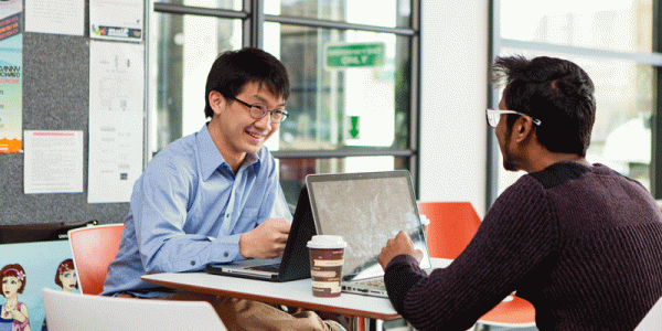 Students with laptops in Liberty building