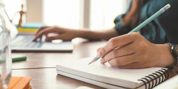 Woman writing in a notepad
