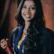Portrait of MA student Chamila Karunarathne, she is smiling and holding a degree scroll.