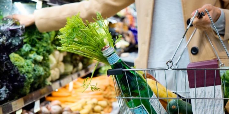 Person buying produce in a supermarket