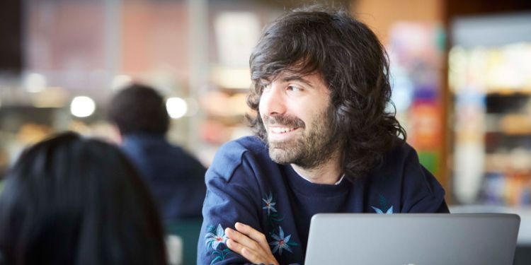 Masters student working at laptop