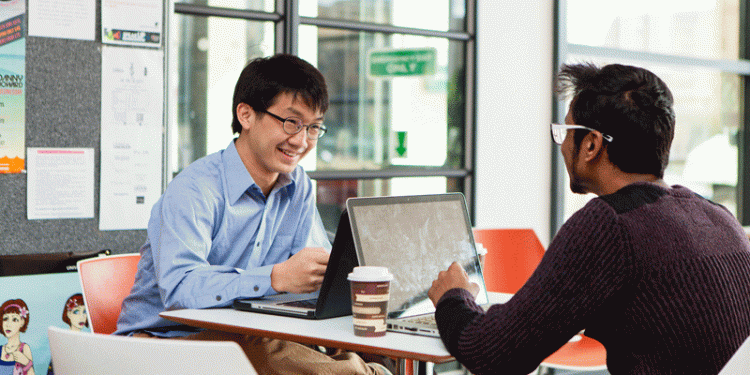 Students with laptops in Liberty building