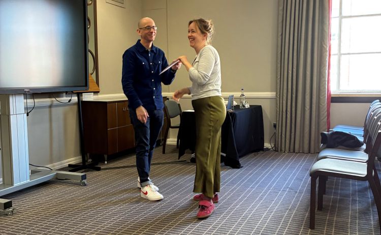 Dr Louise Pears (School of Politics and International Studies) collecting her award from Executive Dean Professor Paul Johnson.